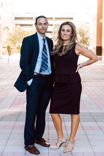Image of Attorneys Jacqueline D. Crowley, Esq and Adam R. Farkas, Esq together in outdoor courtyard
