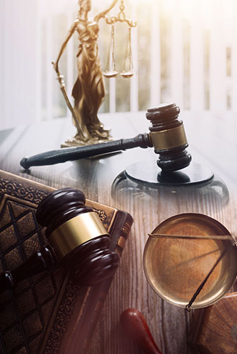 Gavel and Lady Justice on desk representing Sealing of Charges