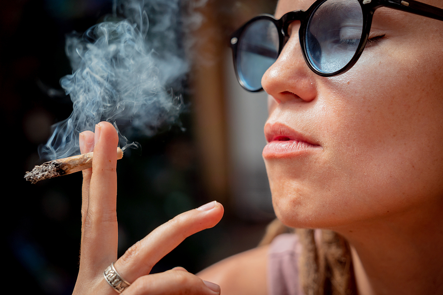 Hippie Style Woman Smoking Cigarettes With Medical Marijuana